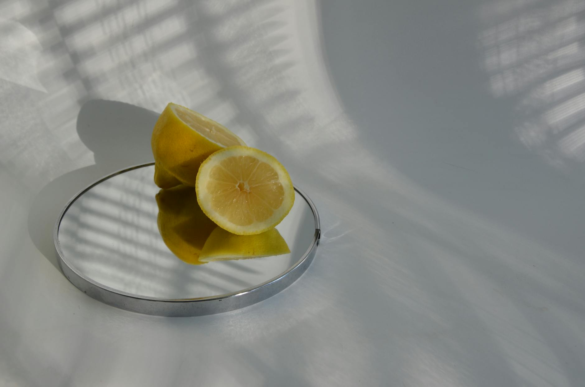 A yellow silicone vibrator surrounded by peeled bananas on a yellow background