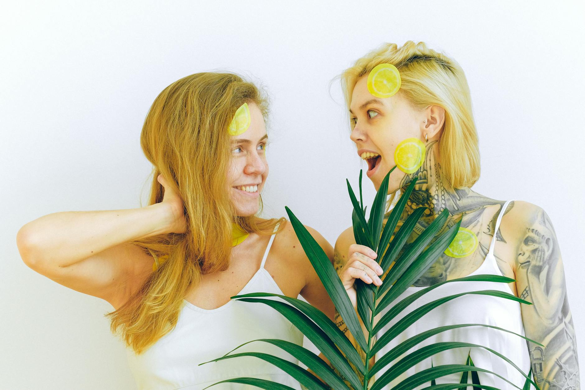 Two women smiling together indoors with joy and closeness