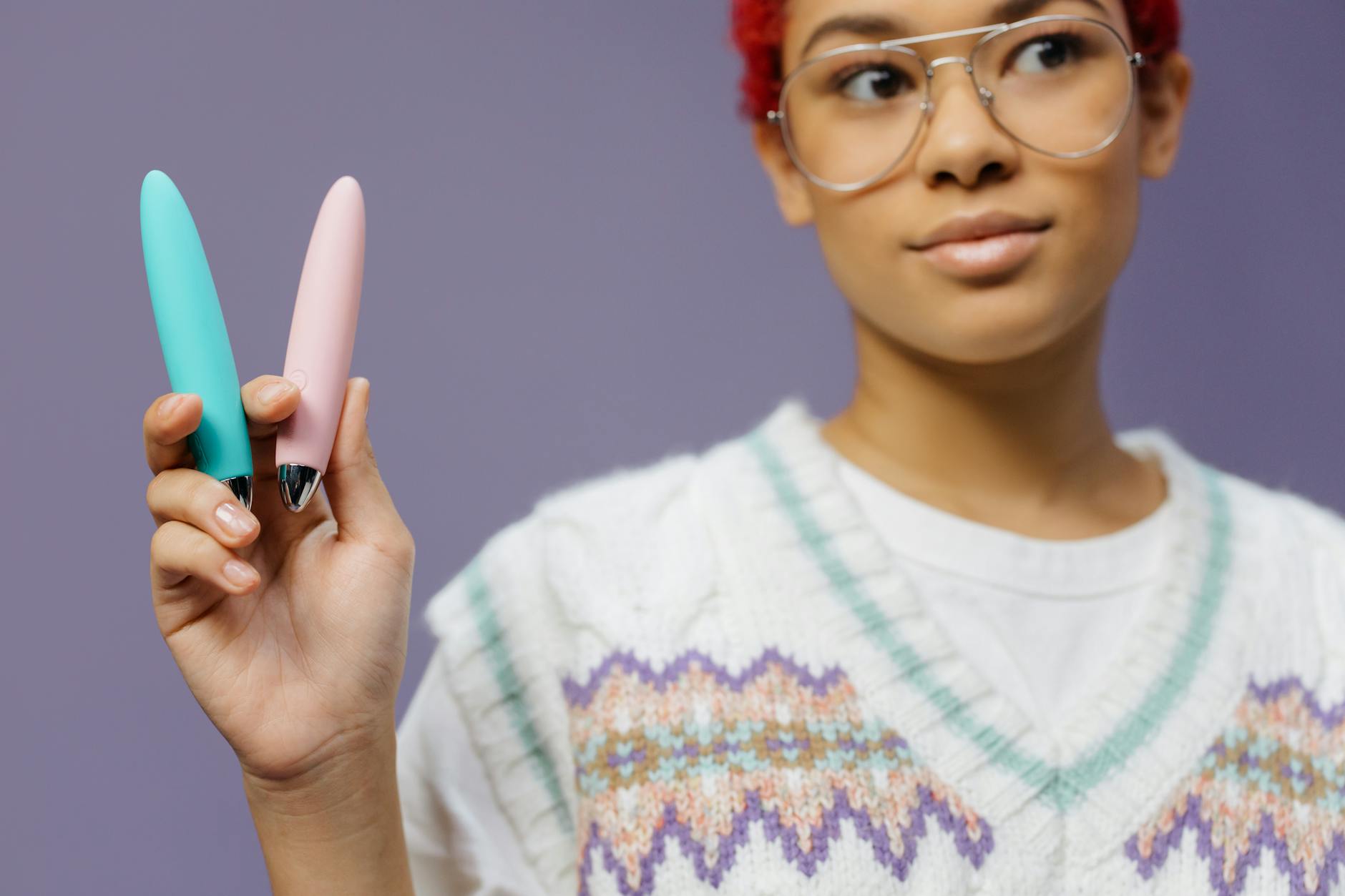 A blue silicone vibrator held confidently in hand, symbolizing self-directed pleasure and bodily autonomy